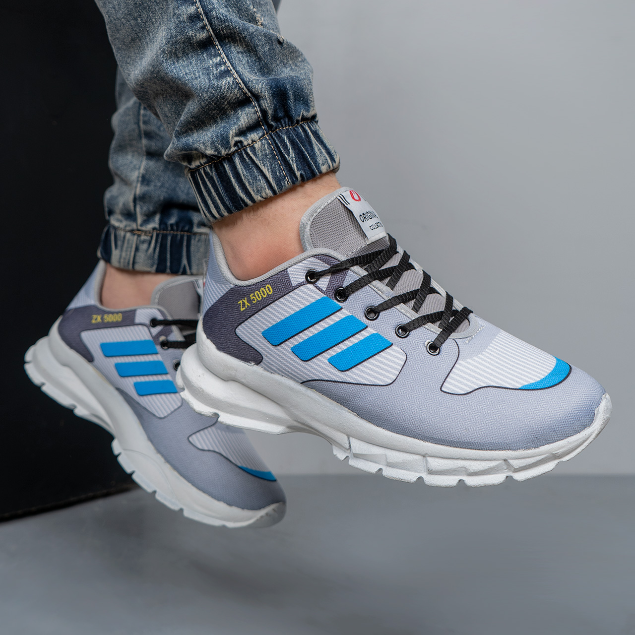 کفش ورزشی مردانه طوسی سه خط آبی مدل ZX5000